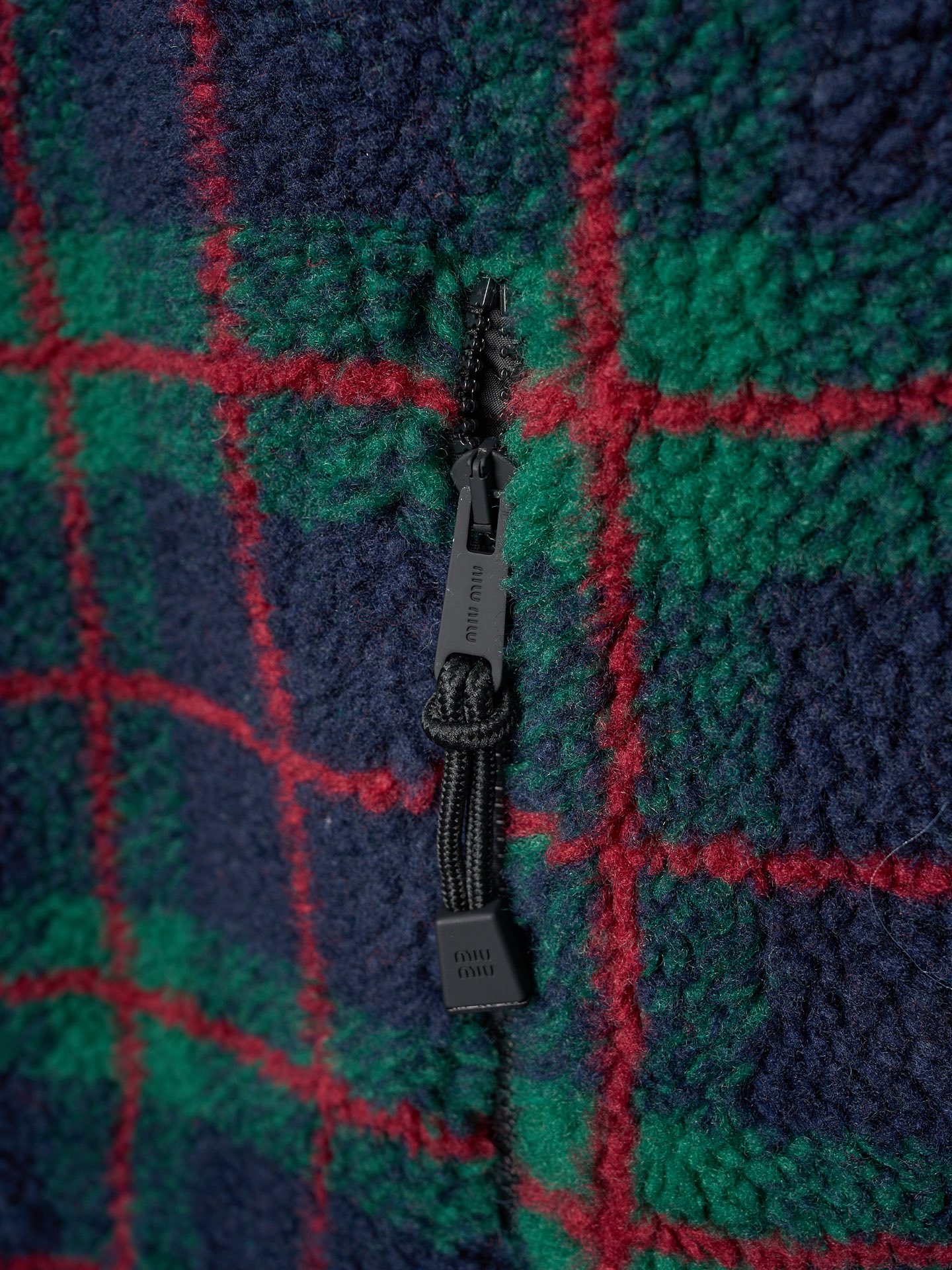 💰260【实物挂拍】MiuMiu/缪缪 羊羔绒格子刺绣拉链外套 【颜色】绿色 灰色 【现货】S M L XL 经典夹克在这款中被重新诠释，加入羊毛以增加厚度和柔软度。经典格纹图案汲取男装风格灵感，重新诠释运动女性气质的风格密码。 Oversize版型. 无衬里长袖立领.正面拉链开合 侧袋.双头钩针底边.刺绣徽标 采用80%羊毛，20%棉。该款面料原版定织定染，100%还原。内衬口袋布采用100%尼龙料， 后领位置搭配100%羊毛泰迪绒。 拉链采用尼龙与胶牙材料结合，拉牙采用欧款胶牙。下摆搭配原版刻字弹力扣。 刺绣采用3D立体刺绣工艺，刺绣logo饱满立体。呈现出高端视觉效果。
