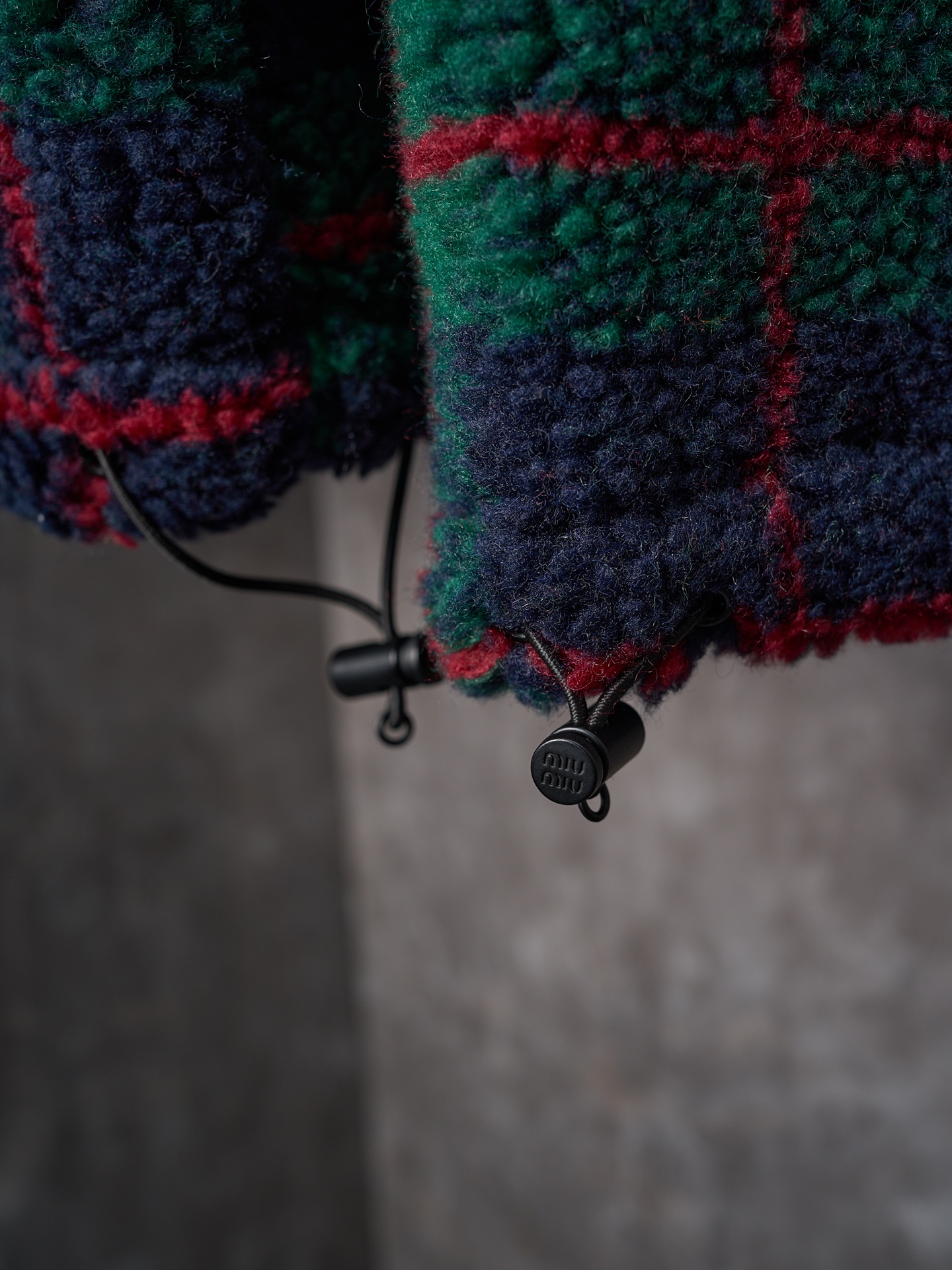 💰260【实物挂拍】MiuMiu/缪缪 羊羔绒格子刺绣拉链外套 【颜色】绿色 灰色 【现货】S M L XL 经典夹克在这款中被重新诠释，加入羊毛以增加厚度和柔软度。经典格纹图案汲取男装风格灵感，重新诠释运动女性气质的风格密码。 Oversize版型. 无衬里长袖立领.正面拉链开合 侧袋.双头钩针底边.刺绣徽标 采用80%羊毛，20%棉。该款面料原版定织定染，100%还原。内衬口袋布采用100%尼龙料， 后领位置搭配100%羊毛泰迪绒。 拉链采用尼龙与胶牙材料结合，拉牙采用欧款胶牙。下摆搭配原版刻字弹力扣。 刺绣采用3D立体刺绣工艺，刺绣logo饱满立体。呈现出高端视觉效果。