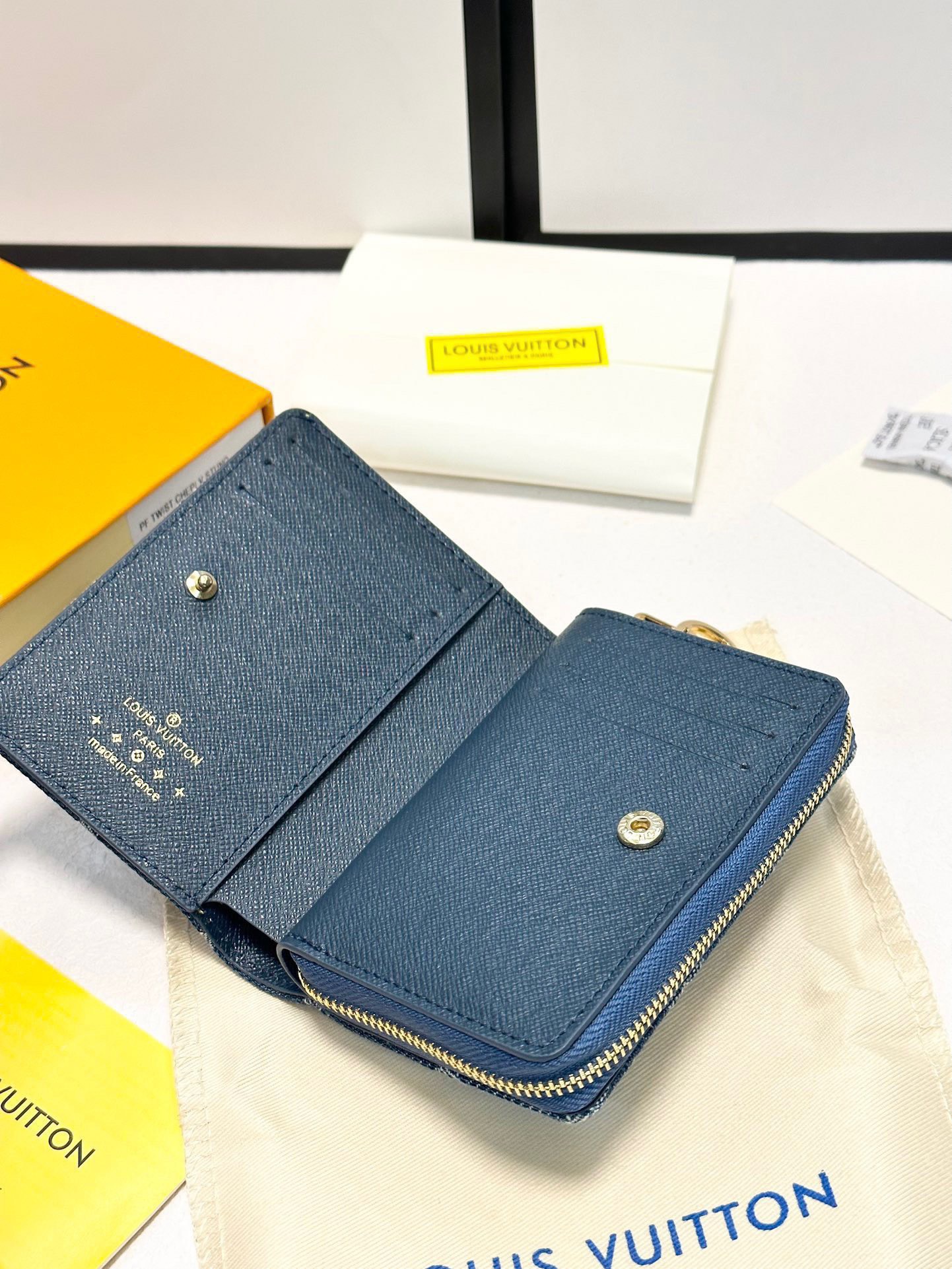 p100🎀颜色 蓝🎀尺寸 11.5x8.5x2.2🎀Portefeuille Roux&rdquo;采用有机棉制成，并采用交织字母图案的交织字母牛仔布制成。它具有金色 LV 圆形拉手和配套拉链。虽然它是一个小钱包，但它有六个卡位、一个钞票隔层和侧面一个拉链零钱袋