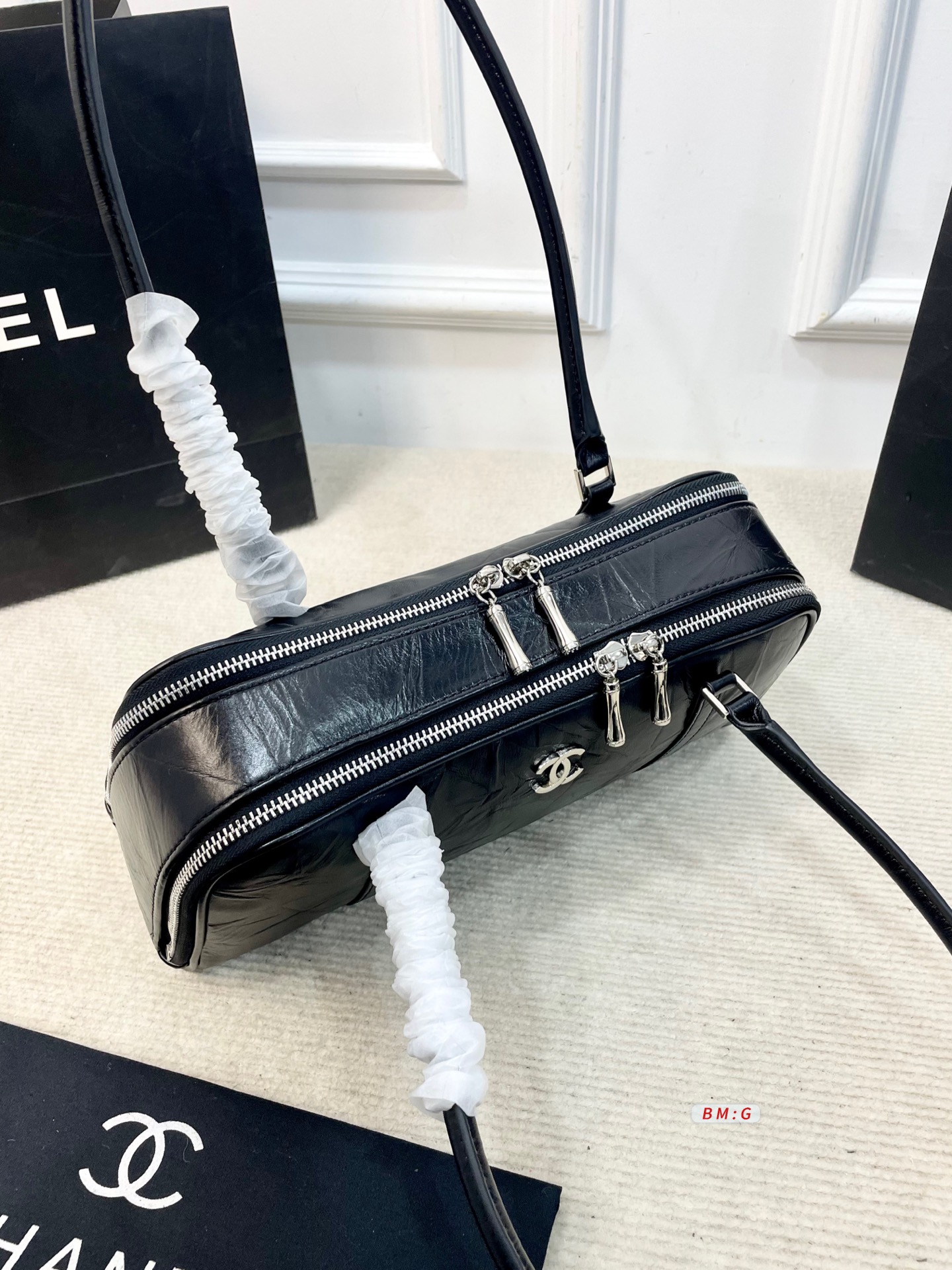💰225 香奈儿黑色油蜡皮保龄球包，经典弧形设计，油蜡皮自带褶皱纹理，复古又高级✨。正面金属双C Logo超有辨识度，拉链开合更安全。内部空间合理，通勤休闲都能装。手柄弧形，手提肩背都OK，实用又时髦。 尺寸：31*9*16.5