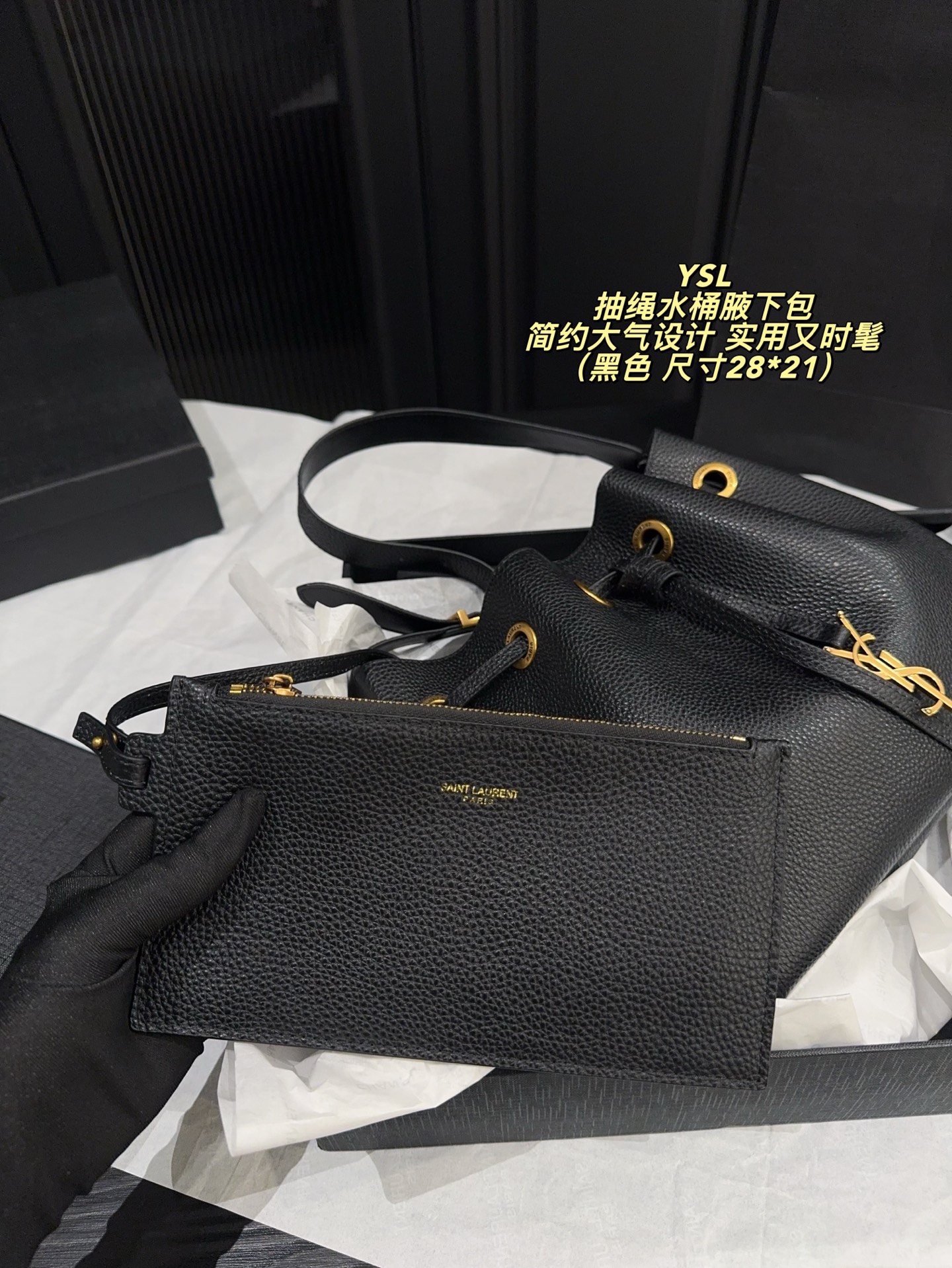 P200配折叠盒⚠️尺寸28*21 圣罗兰 YSL 抽绳水桶腋下包 黑色荔枝纹牛皮，质感细腻耐用，金属抽绳十YSL标志超有辨识度。尺寸适中，通勤休闲都能用，手提斜挎随心切换，内部空问合理，日常物品轻松收纳。简约大气设计，百搭不挑风格，秋冬深色系穿搭必备，实用又时髦！