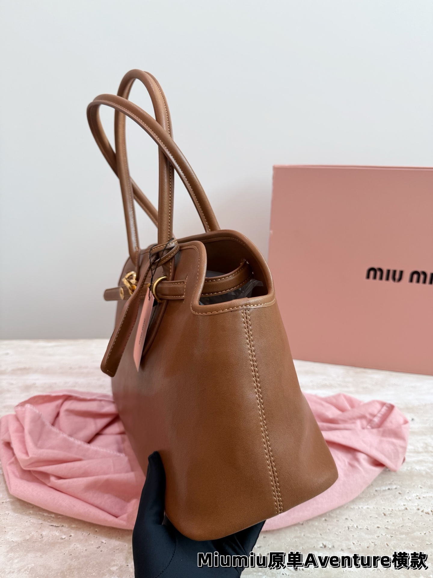 P240 miumiu复古Aventure系列贝壳包 Aventure系列贝壳手提/斜挎包.上线啦! 24ss最流行款式，做旧褪色感的皮革颜色与质地，配上金属皮带搭扣高级又复古，采用小牛皮制作的包身设计精致，方正复古的造型 手提腋下斜挎包随意切换! 优雅通勤超好穿快快加入miu女孩吧! 尺寸:超大号46*23cm复古包#牛皮包包