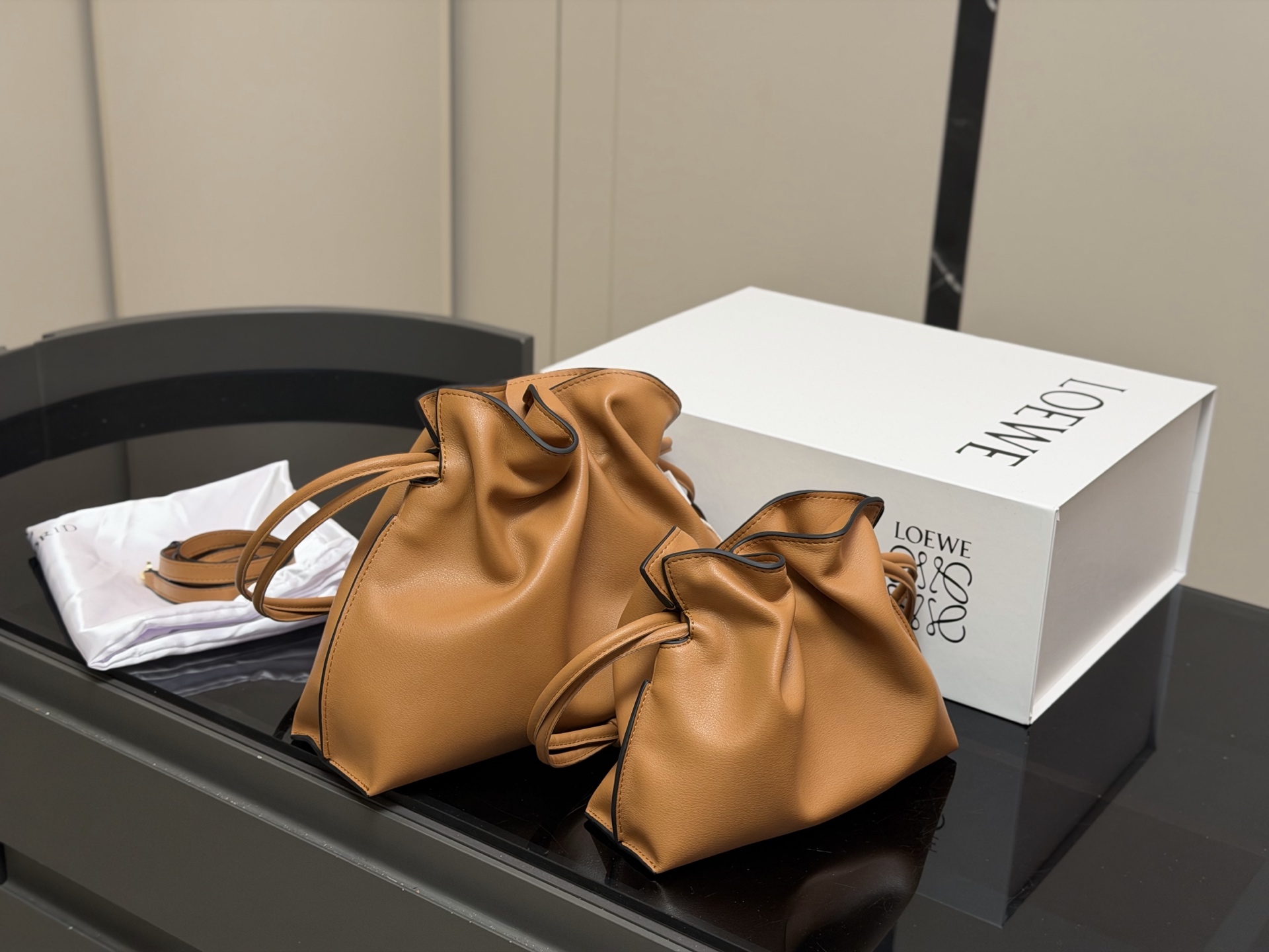 &yen;235 &yen;215 配折叠盒 Loewe 罗意威 Flamenco福袋包 手感柔软细腻，搭配Anagram金属标志，低调又奢华。容量大，通勤休闲都很适合。肩带可拆卸调节，手提、单肩、斜挎随心切换，灵活百搭國。磁扣开合方便，内部空问宽敞，收纳无压力。Flamenco 系列灵感源自西班牙弗拉门戈舞，优雅又有艺术气息。 尺寸:29.25cm 22.18cm